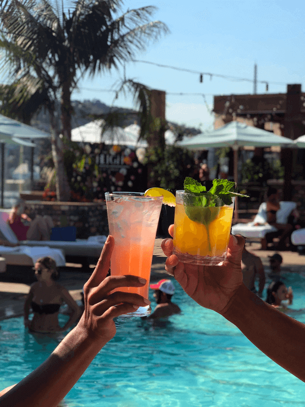 to hands holding drinks