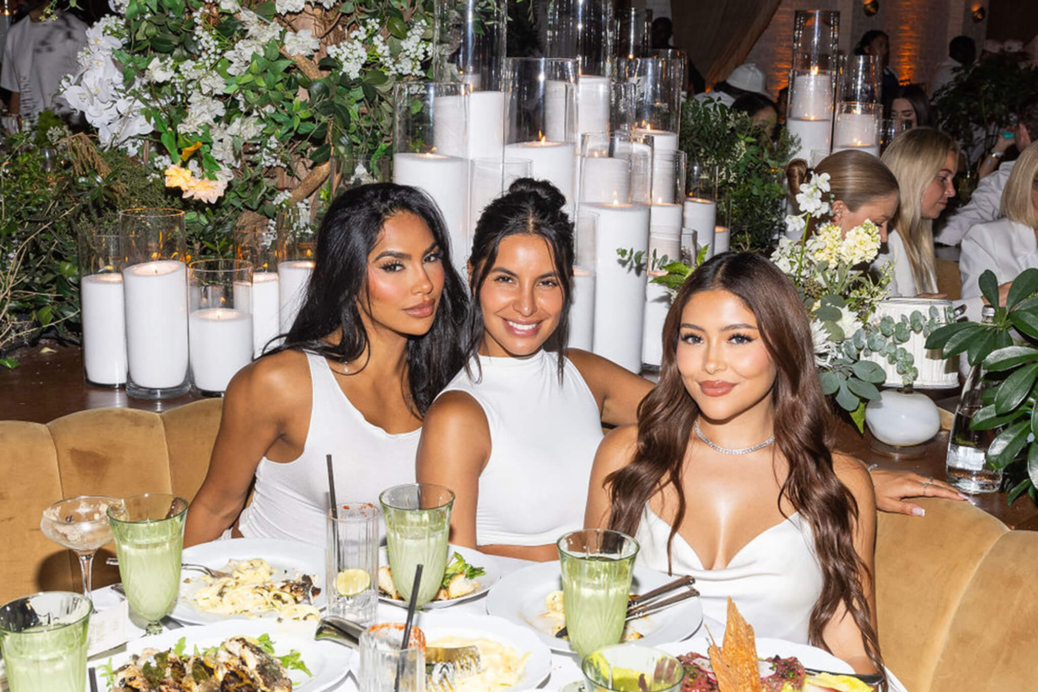 girls at white party with food and drinks and candles