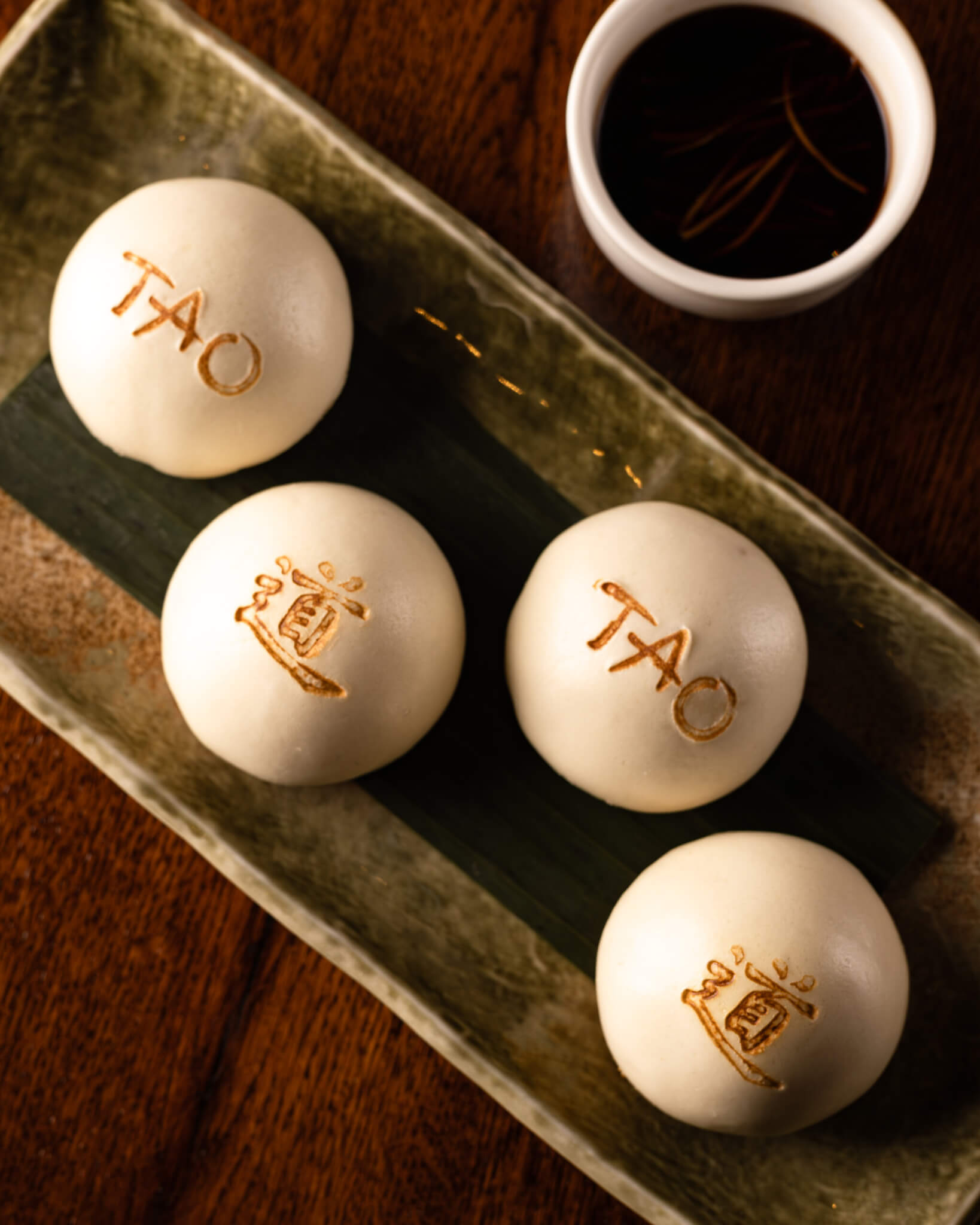 TAO Bao Buns on plate with dipping sauce in ramekin