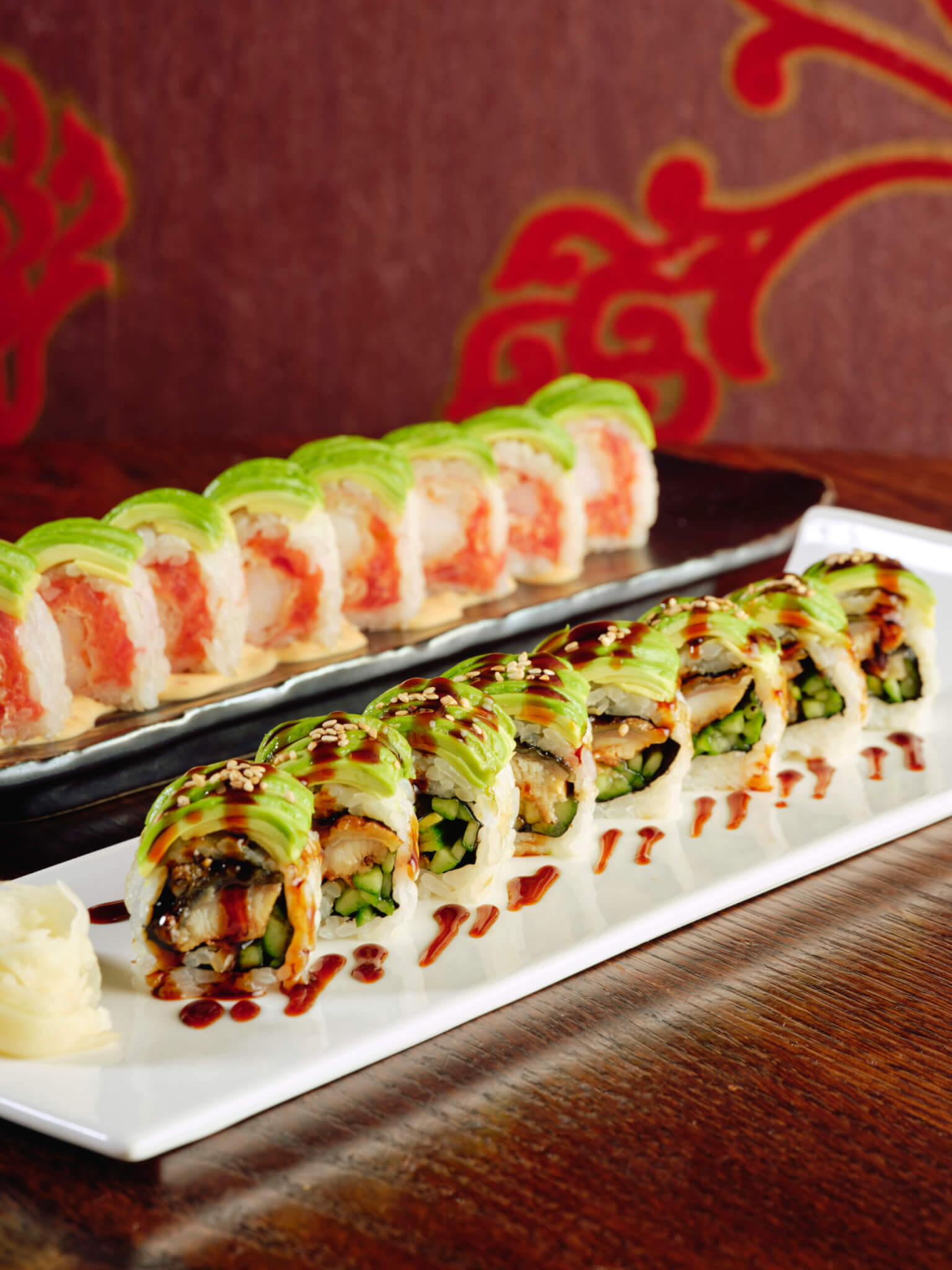 sushi rolls topped with avocado