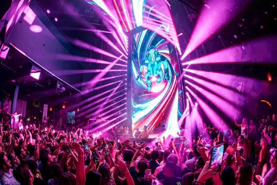 crowd partying at marquee nightclub las vegas with astronaut on LED screen