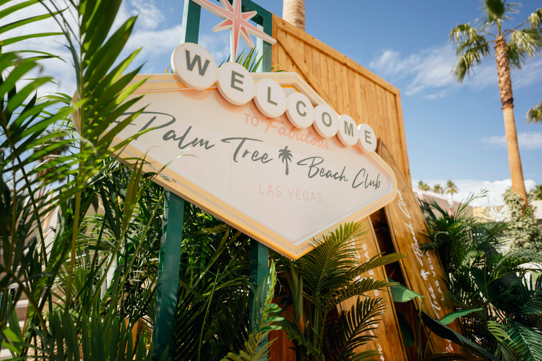 palm tree beach club welcome sign