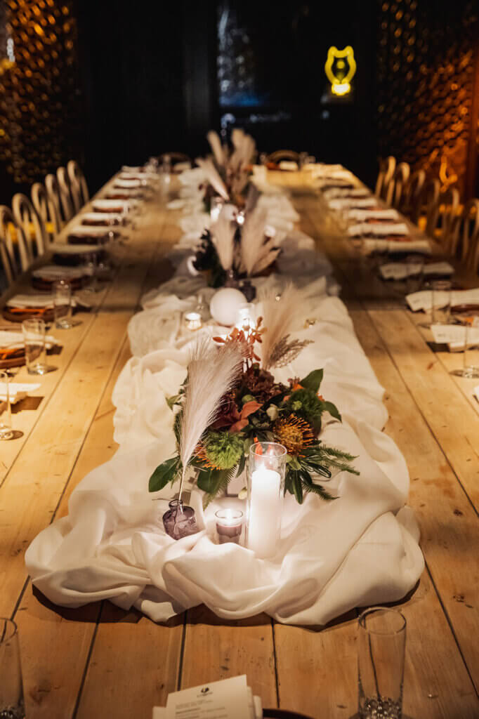 table scape with flowers and candles and feather