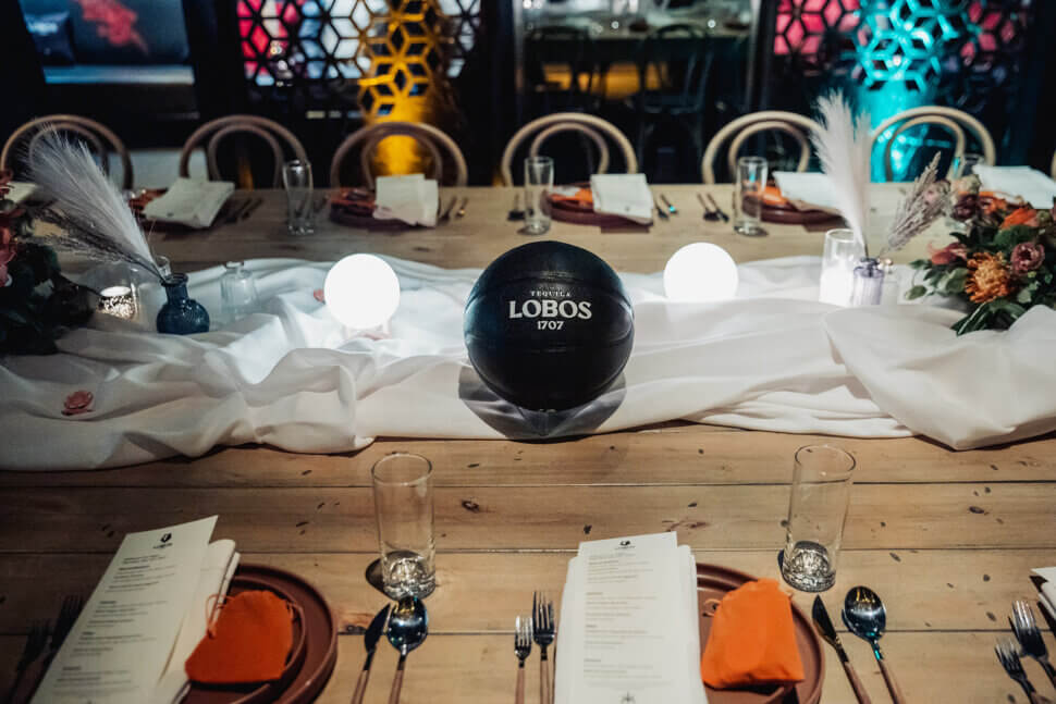 table scape with flowers and lights and lobos basketball and table placement