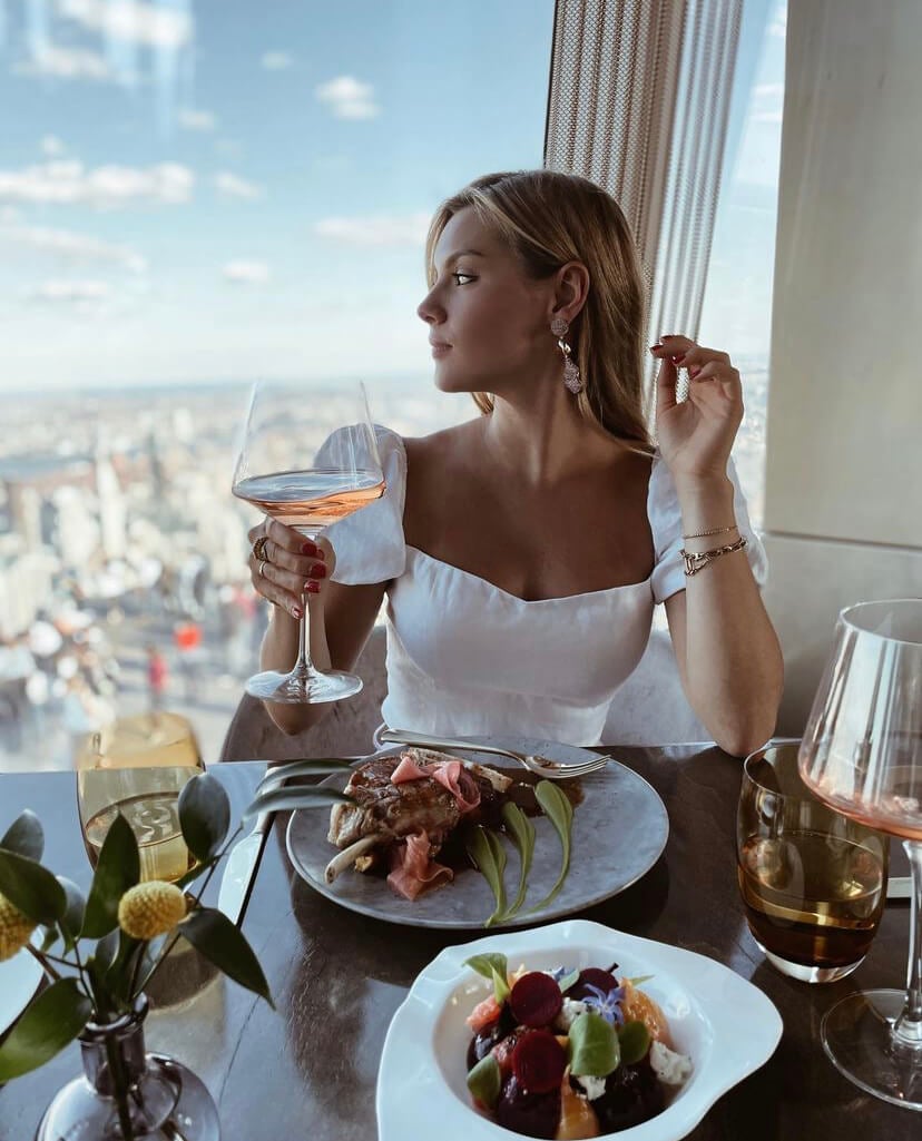 woman at peak with drink and food