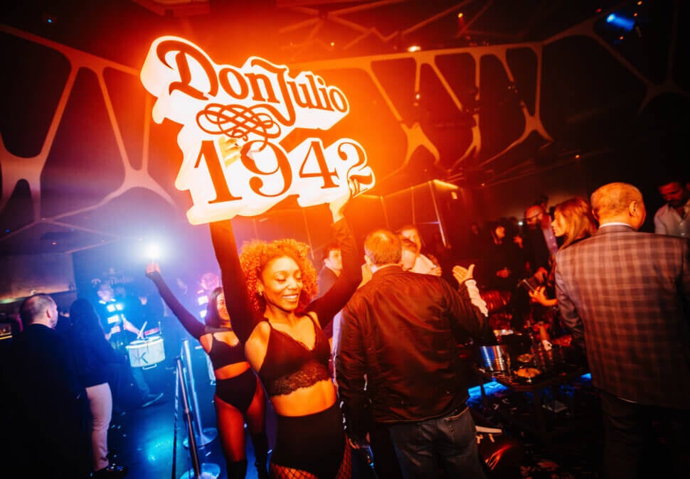 Don Julio sign with waitress in crowd