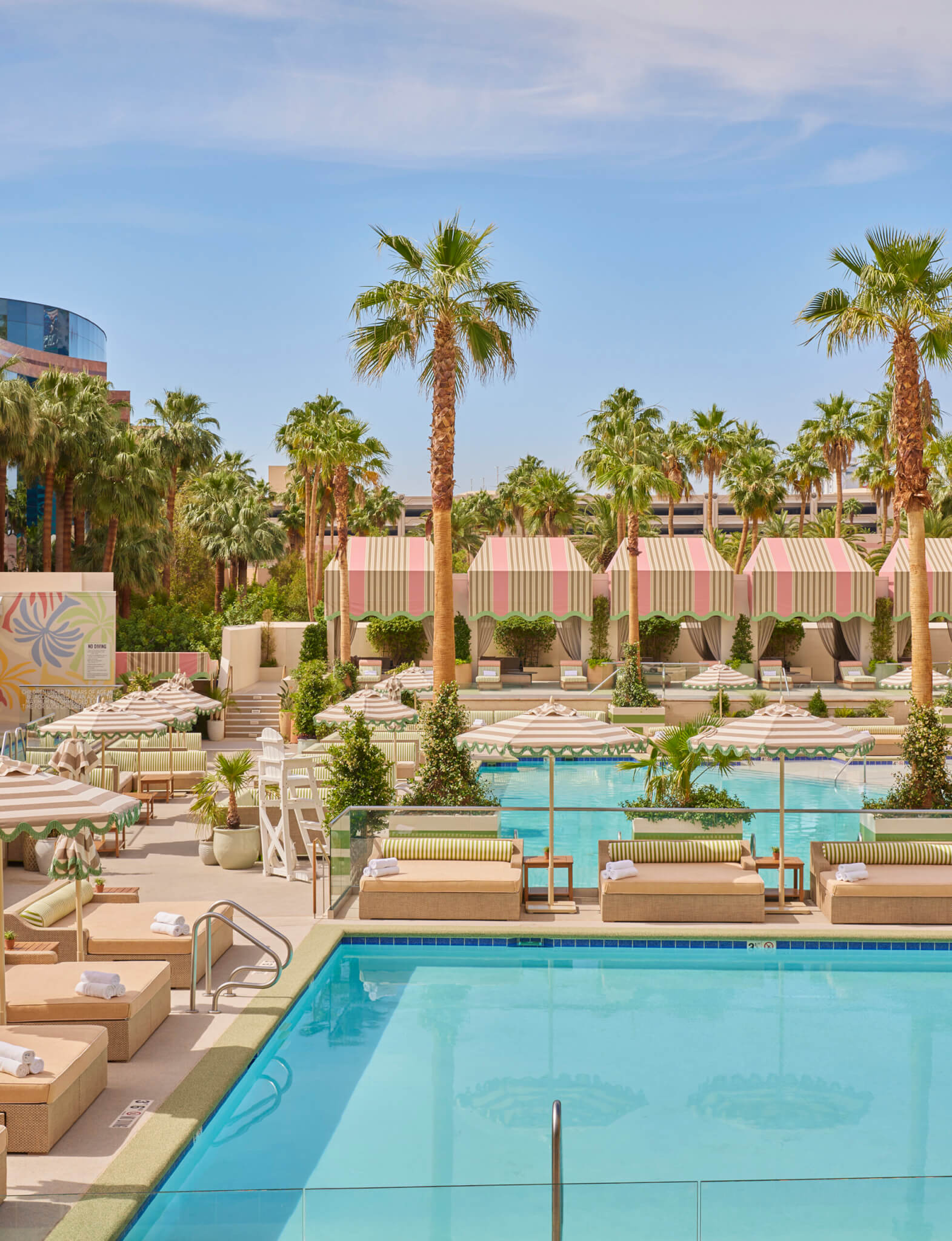 palm tree beach club pool and daybeds