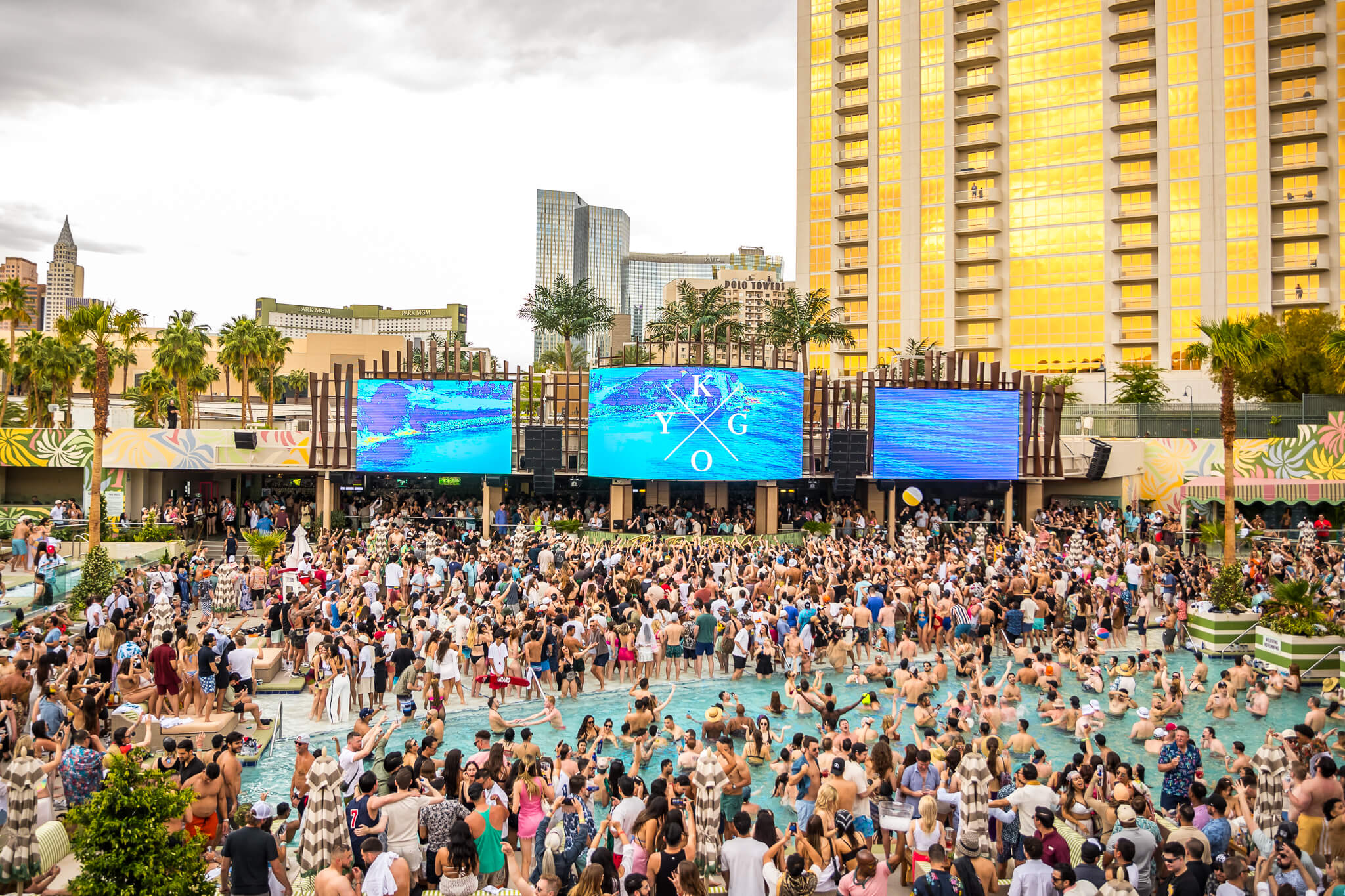 crowd at palm tree beach club with KYGO on LED