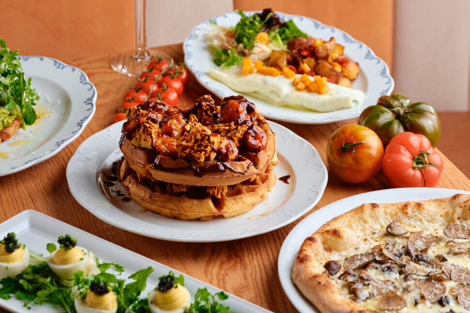 chicken and waffles, omlette with hashbrowns, deviled eggs, tomatoes and truffle pizza