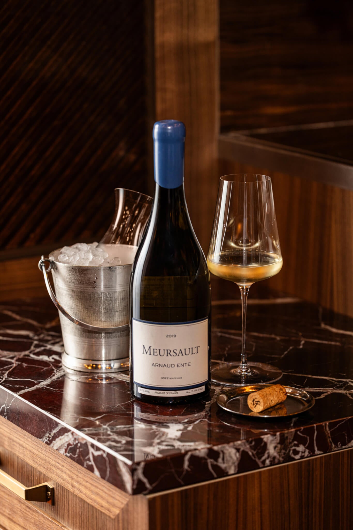 white wine in bottle and glass with bucket of ice